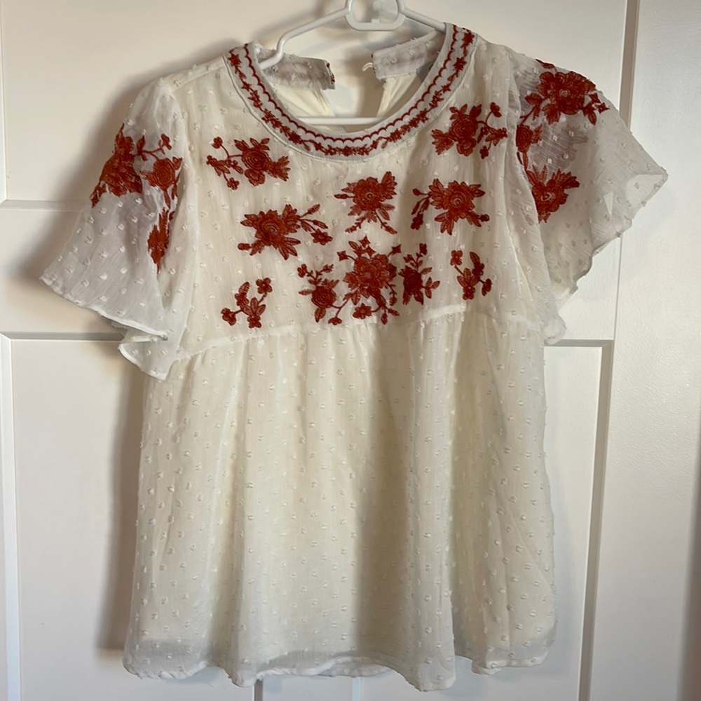 White blouse with orange embroidery